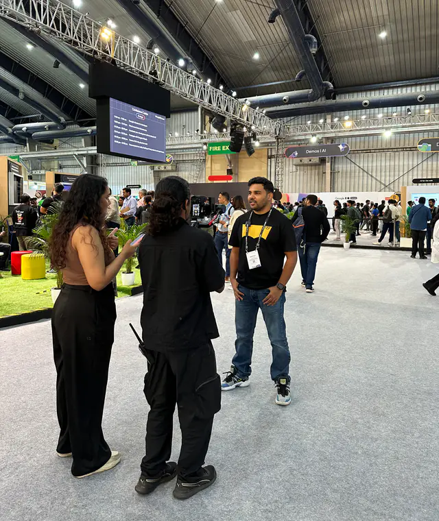 Belal Khan speaking with community members at a developer event